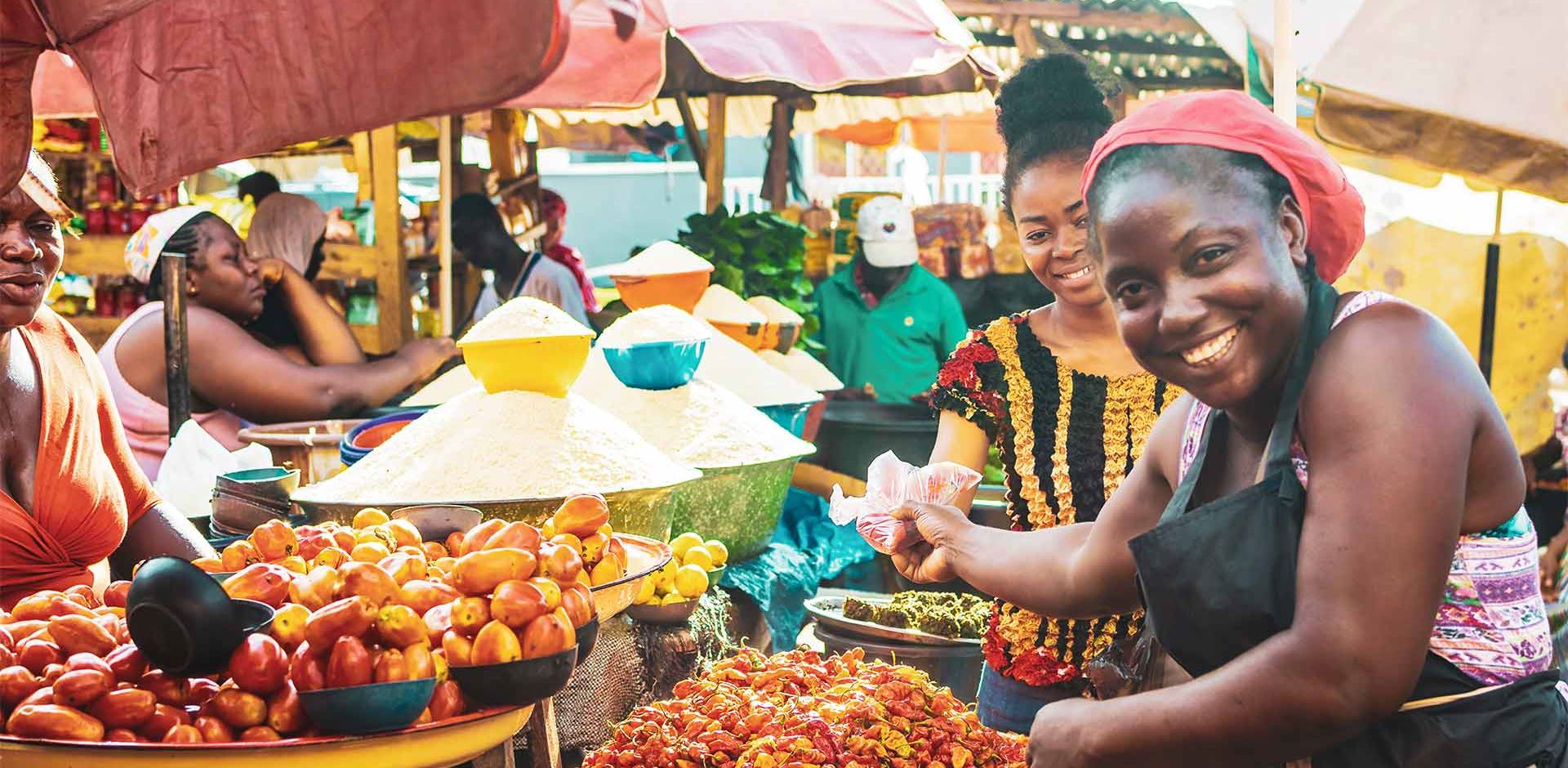 Rejser til Afrika smilende kvinde paa afrikansk frugt market